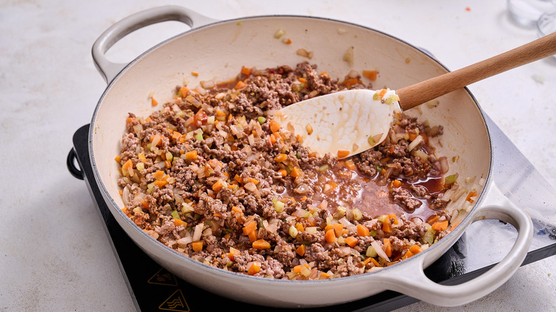 cooking wine in skillet with vegetables