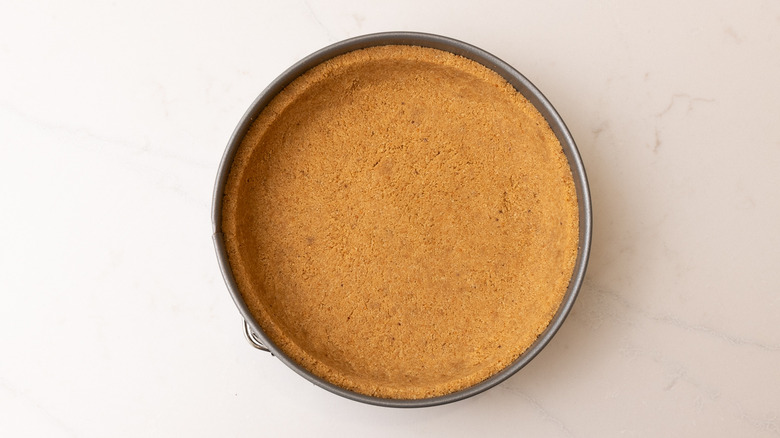 baked graham cracker pie crust in cake pan