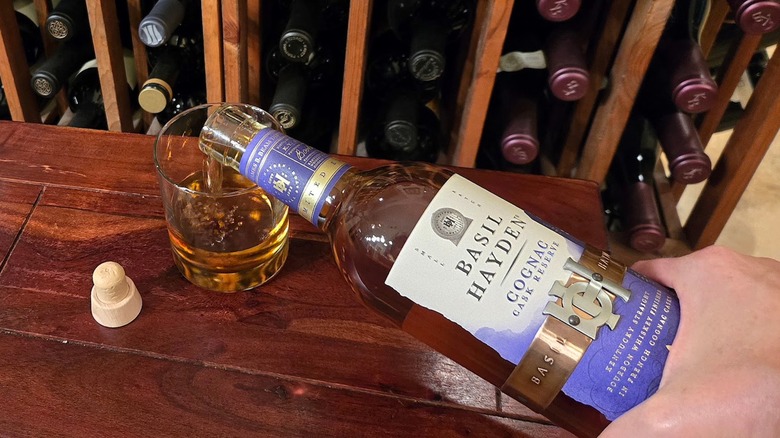 Pouring bottle of Basil Hayden Cognac Cask Bourbon.