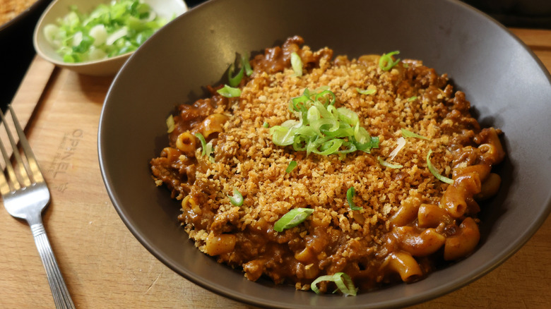 brown bowl of Hmaburger Helper topped with toasted panko breadcrumbs and thinly sliced scallions