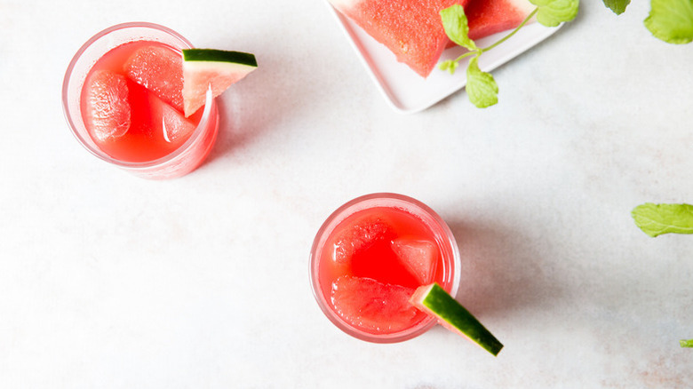 Top down view of two watermelon cocktails, each garnished with a watermelon wedge