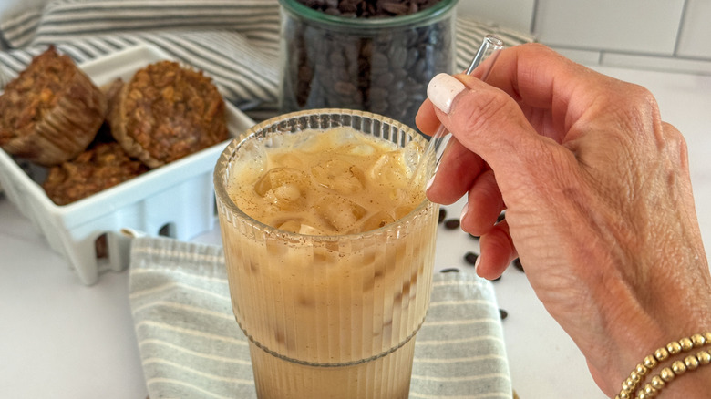hand stirring espresso drink