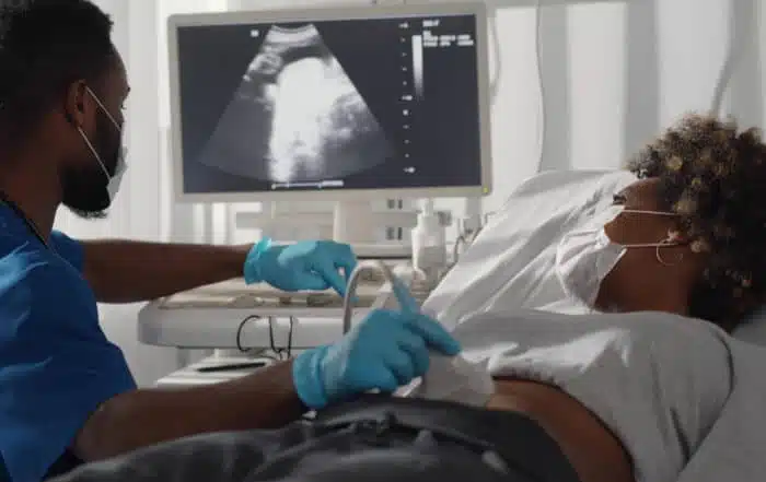 Doctor is doing ultrasound screening for a pregnant woman