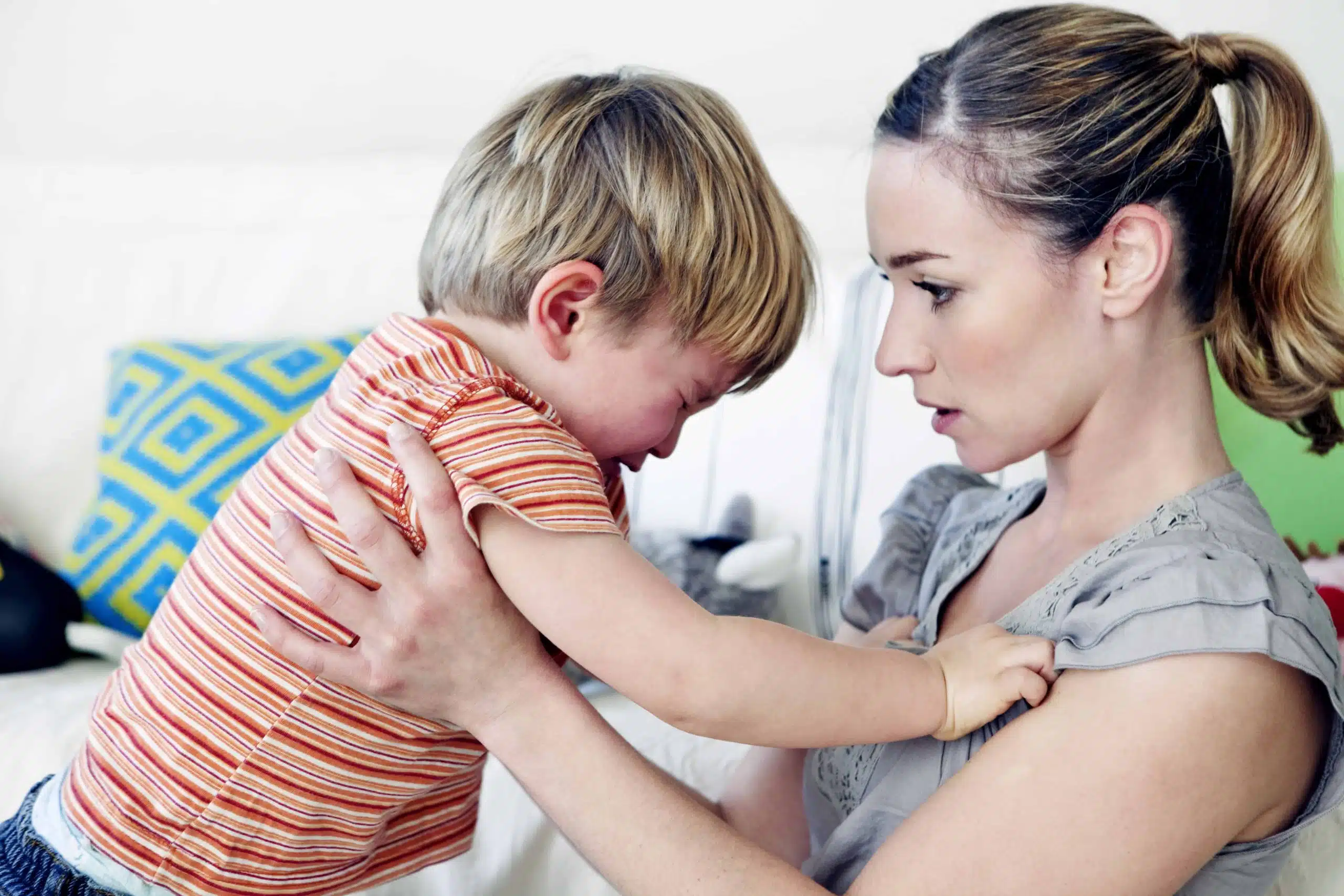 Child in distress as mother comforts and calms him