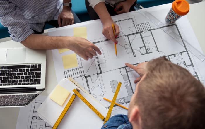 Workers brainstorming and planning an apartment layout