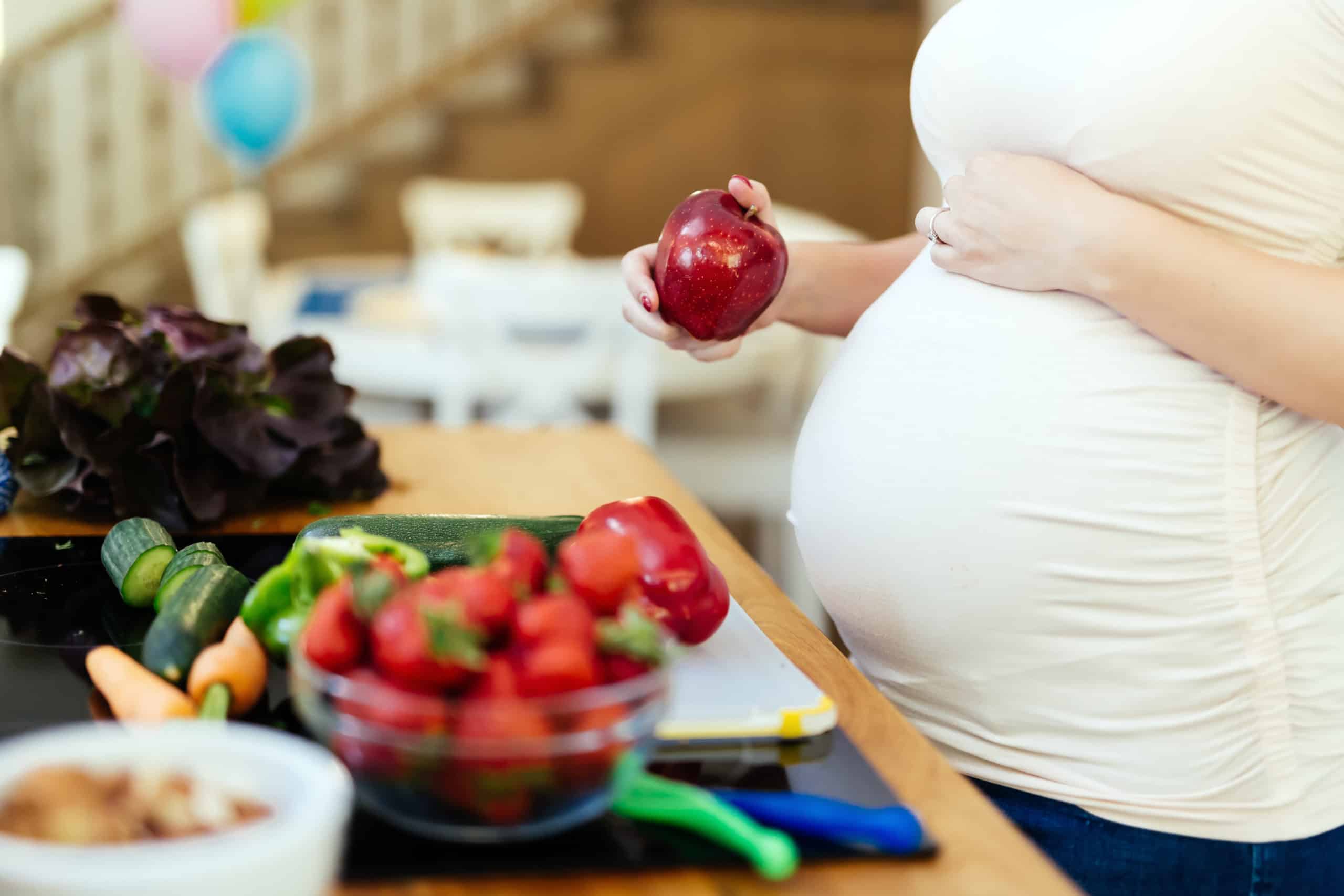 Pregnant woman healthy eating vegetables and fruit