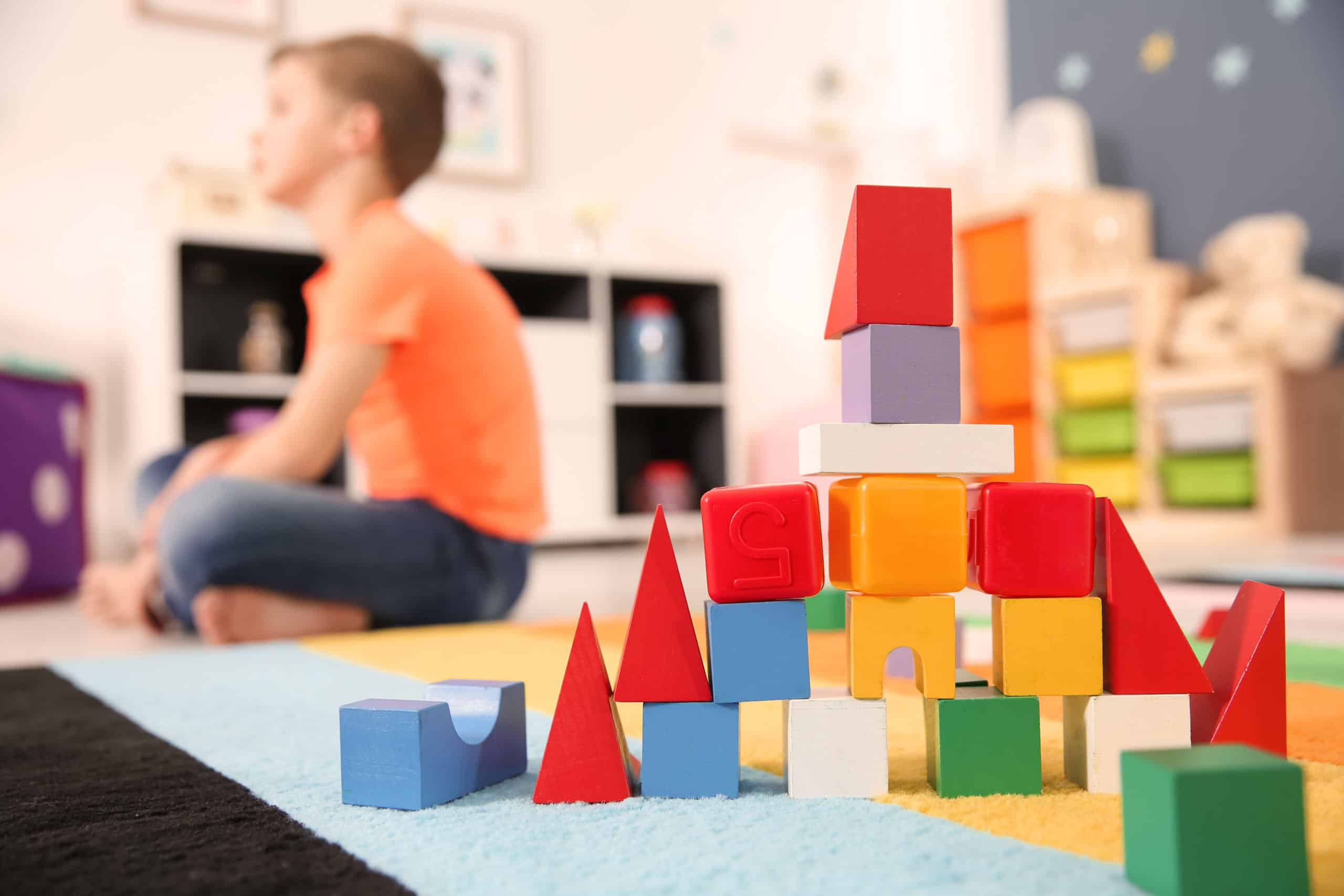 Child sitting on the floor in a kindergarten classroom
