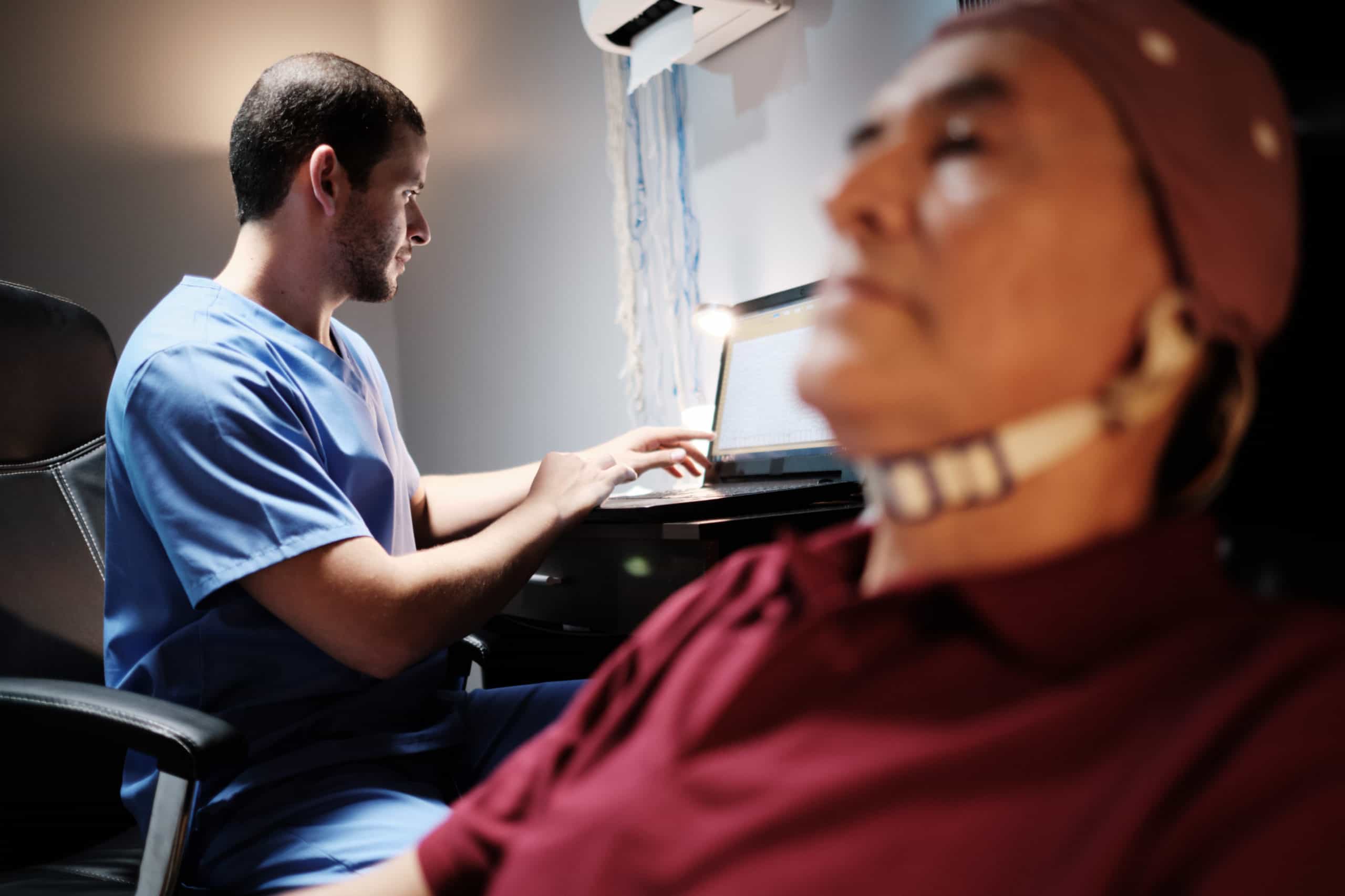 Elderly male patient with Alzheimer's illness, undergoing electroencephalogram examination Senior man with a nurse in clinic for medical evaluation using EEG. Brain illness prevention using technology