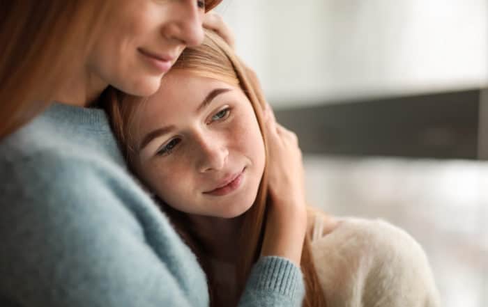 Mother and daughter hugging each other