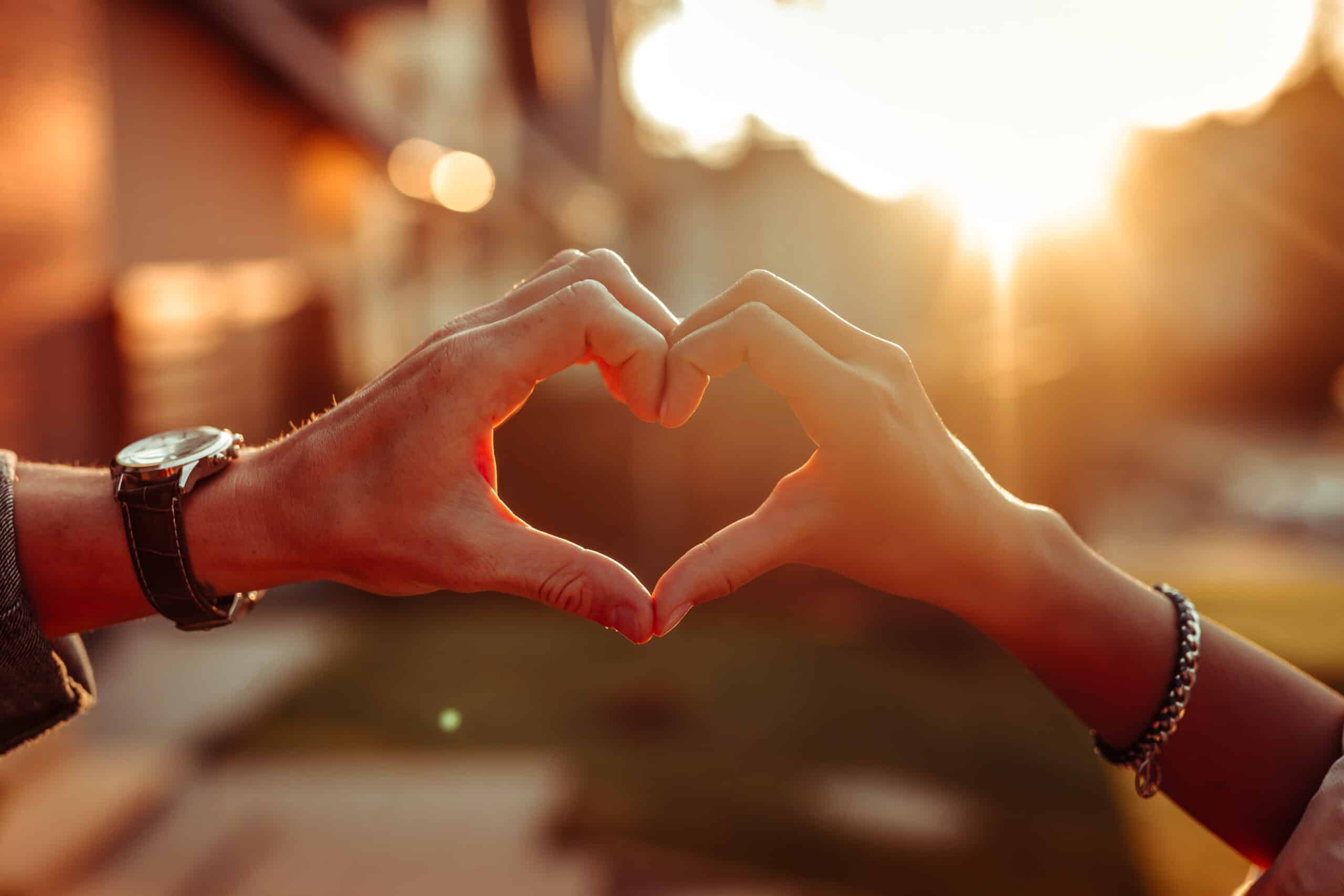 Two hands creating a heart shape with their fingers
