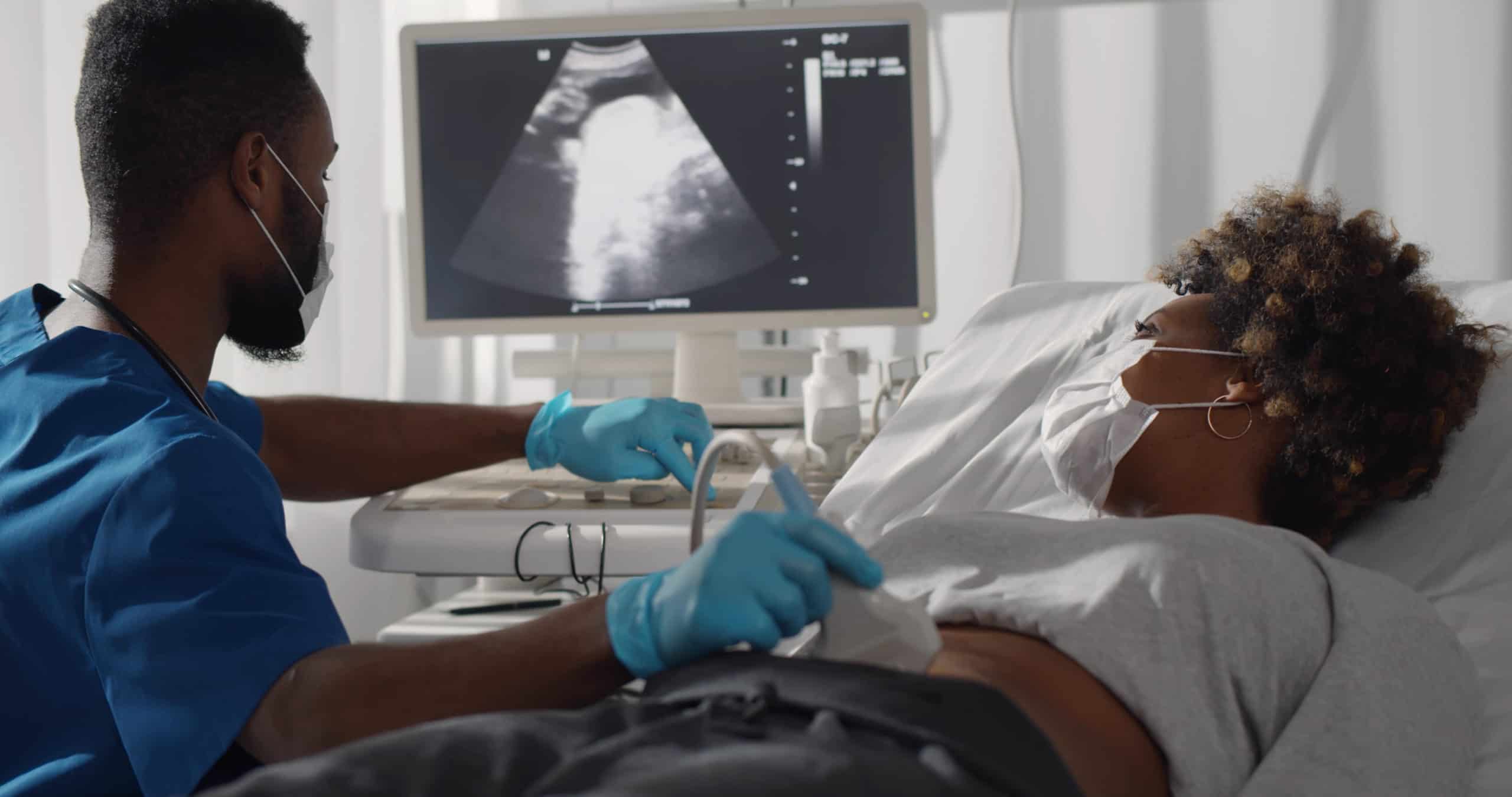 Doctor is doing ultrasound screening for a pregnant woman