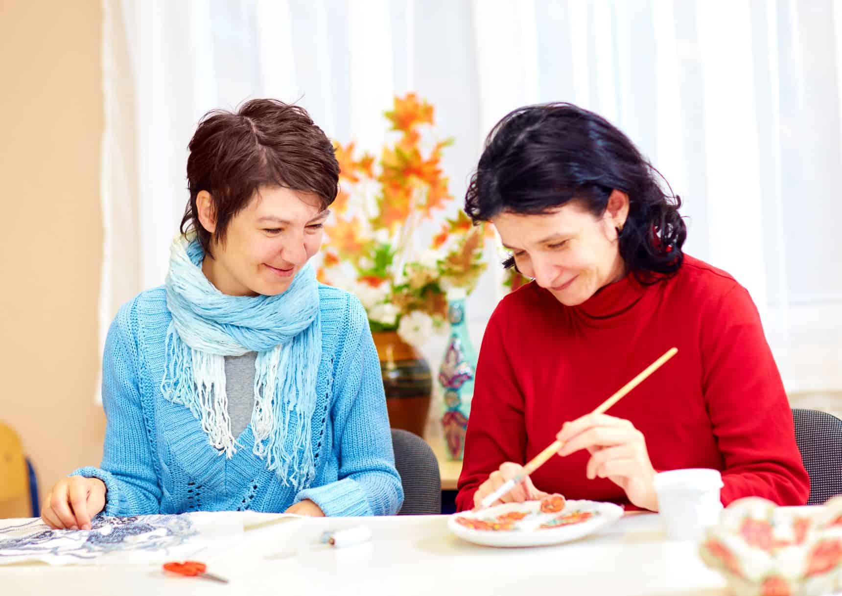 adult women handcrafting plates