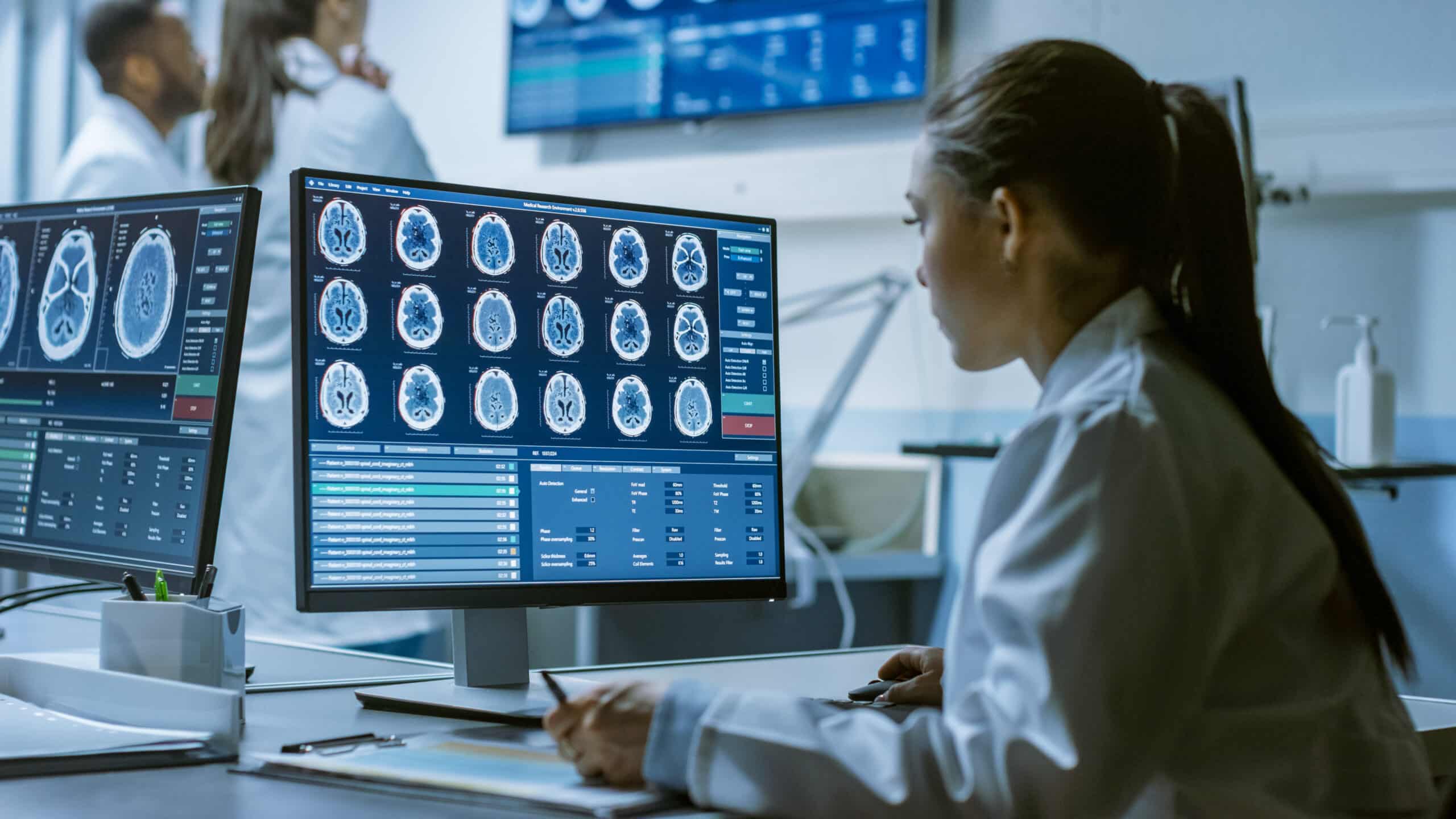 Doctor examining detailed brain scans displayed on a monitor