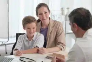 Mature doctor talking to mother and son