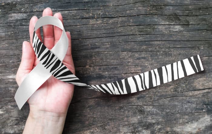 Black and white ribbon on a hand
