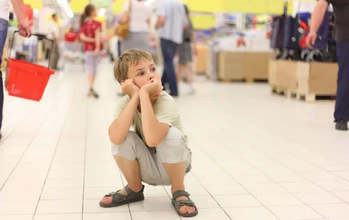 Child looking at items in a supermarket