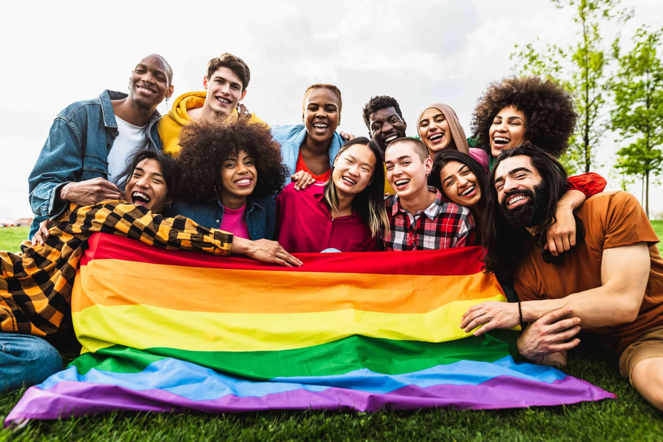 Happy diverse young friends celebrating gay pride festival