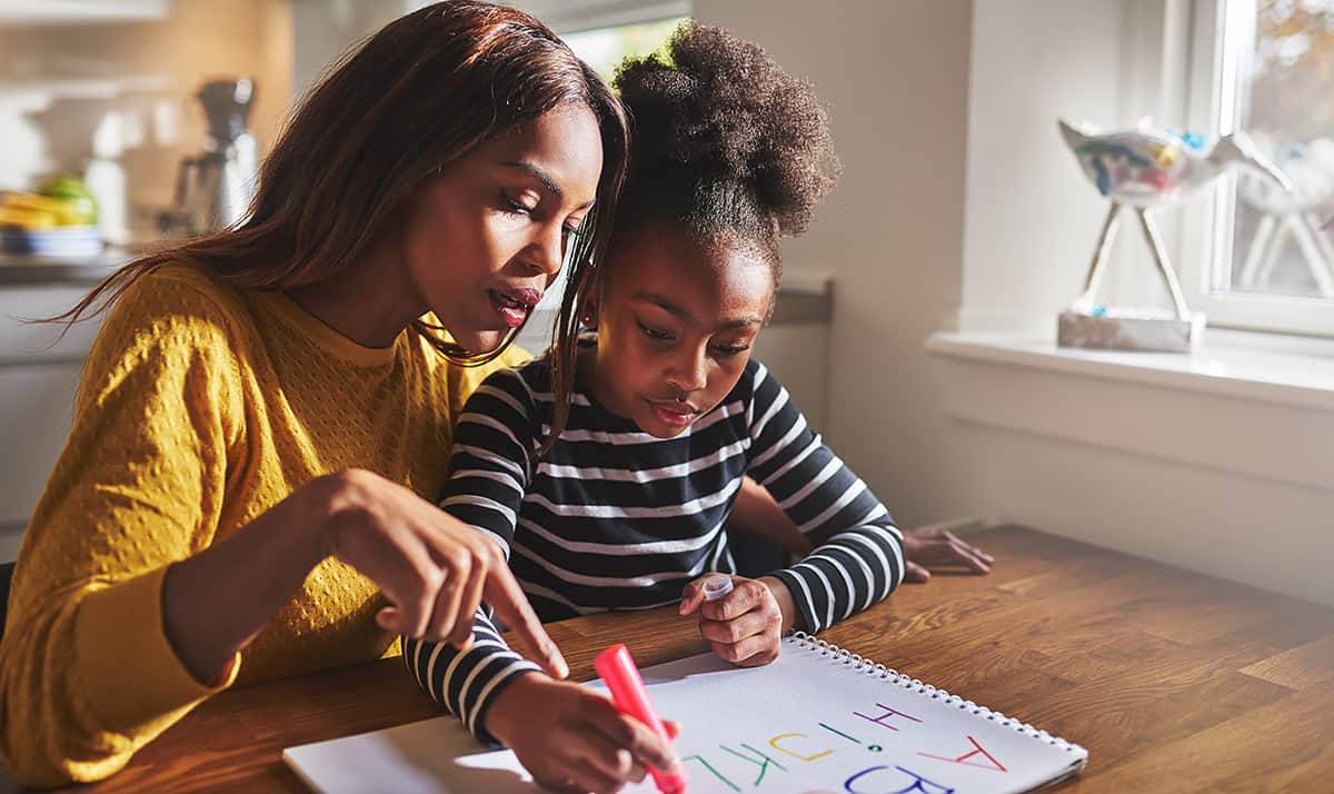 Mom and child studying together, working on homework