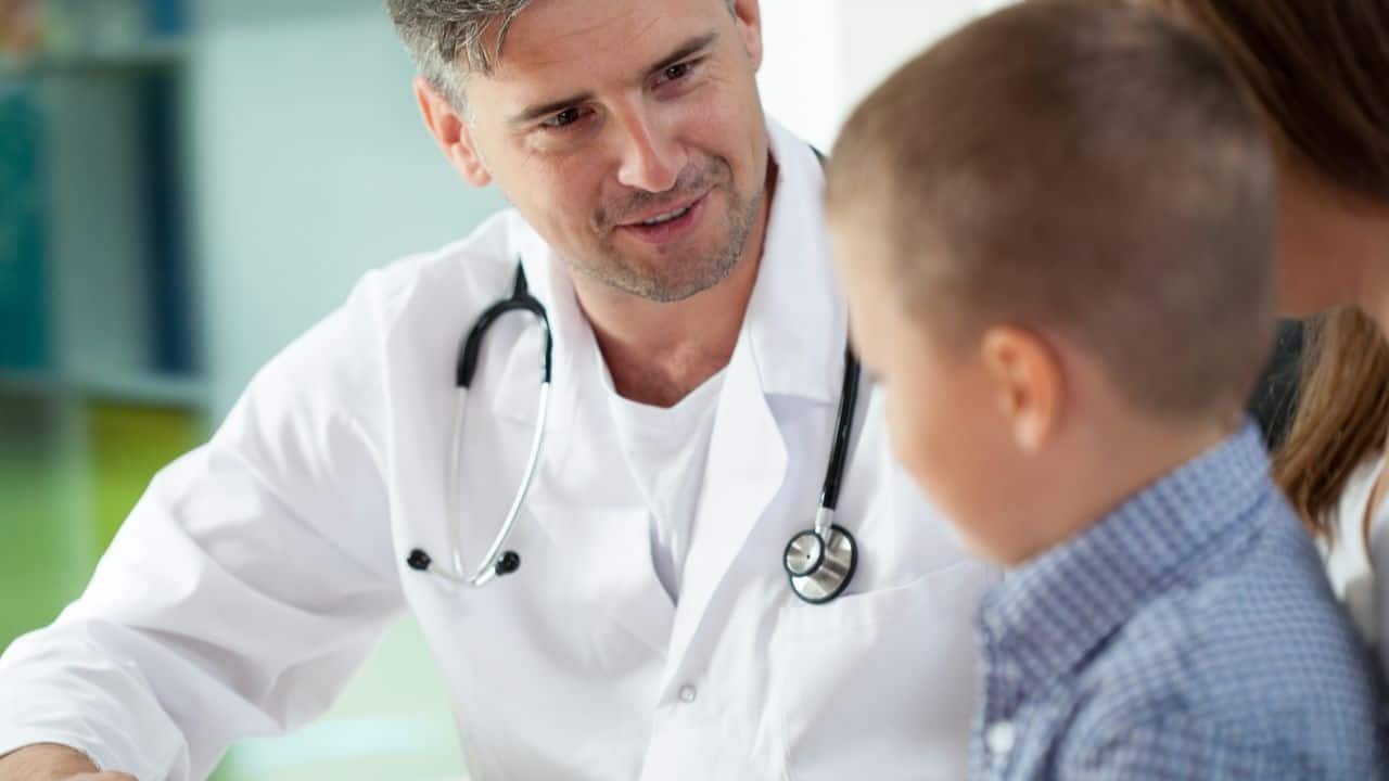 Doctor talking to a child during a check-up