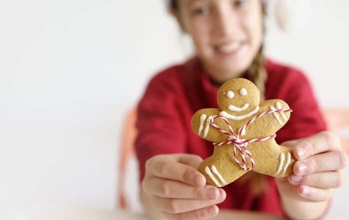 Girl holding gingerbread cookie