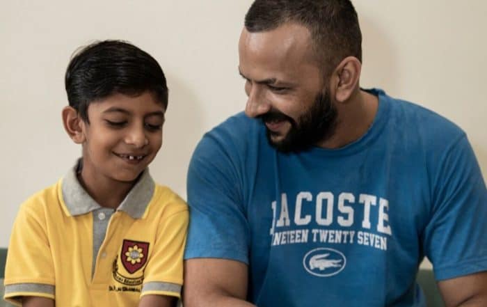 Father and son smiling with happiness
