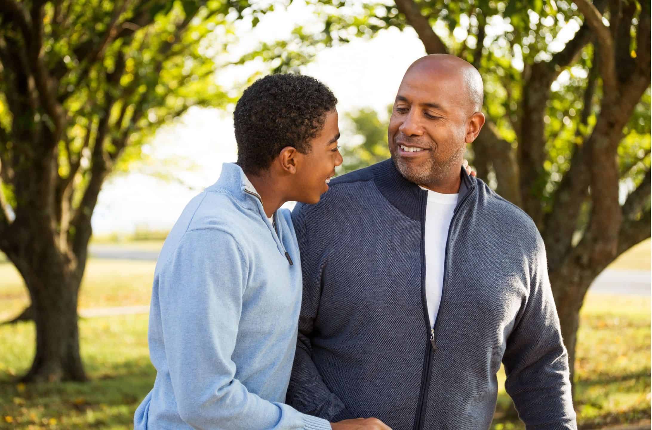 Father and son sharing a joyful moment, smiling and talking
