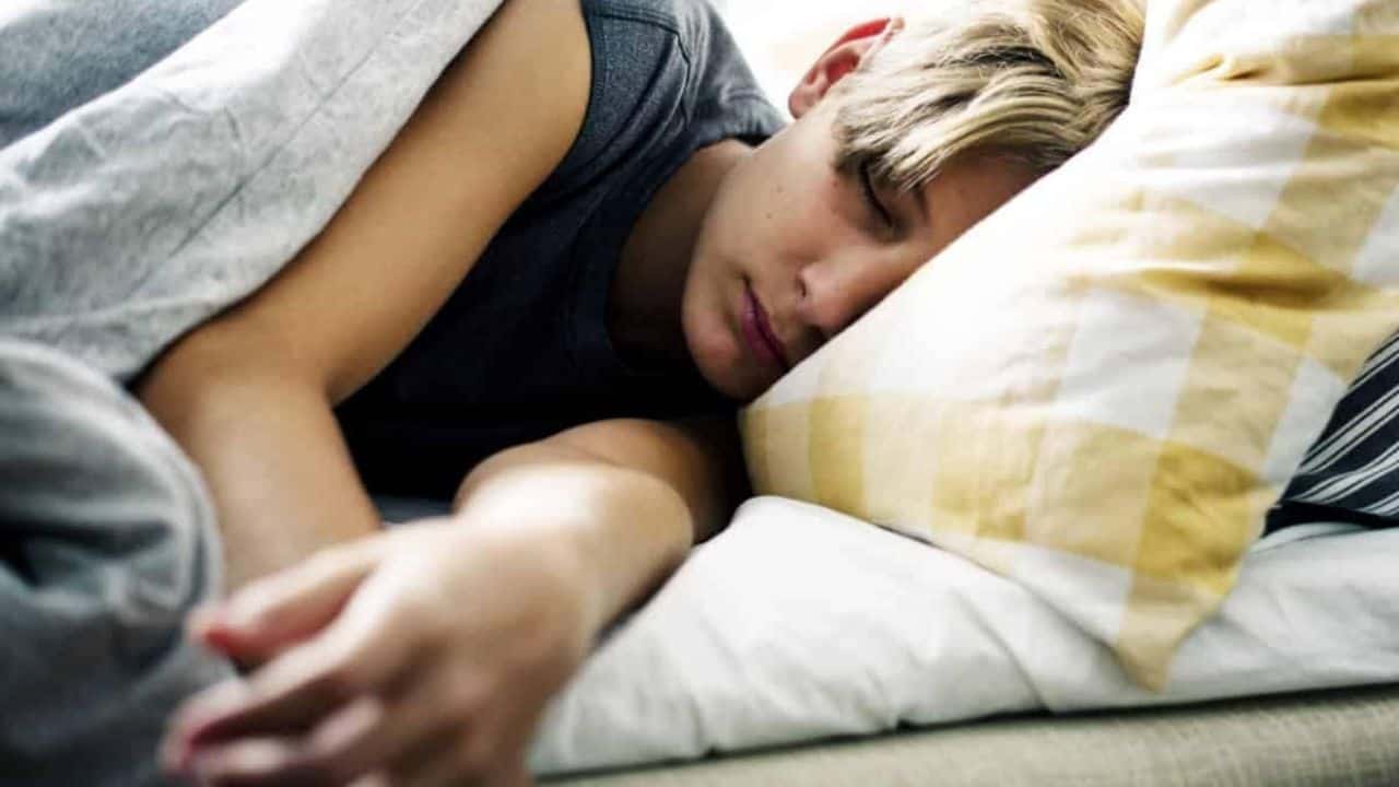 Young kid having a peaceful nap in bed