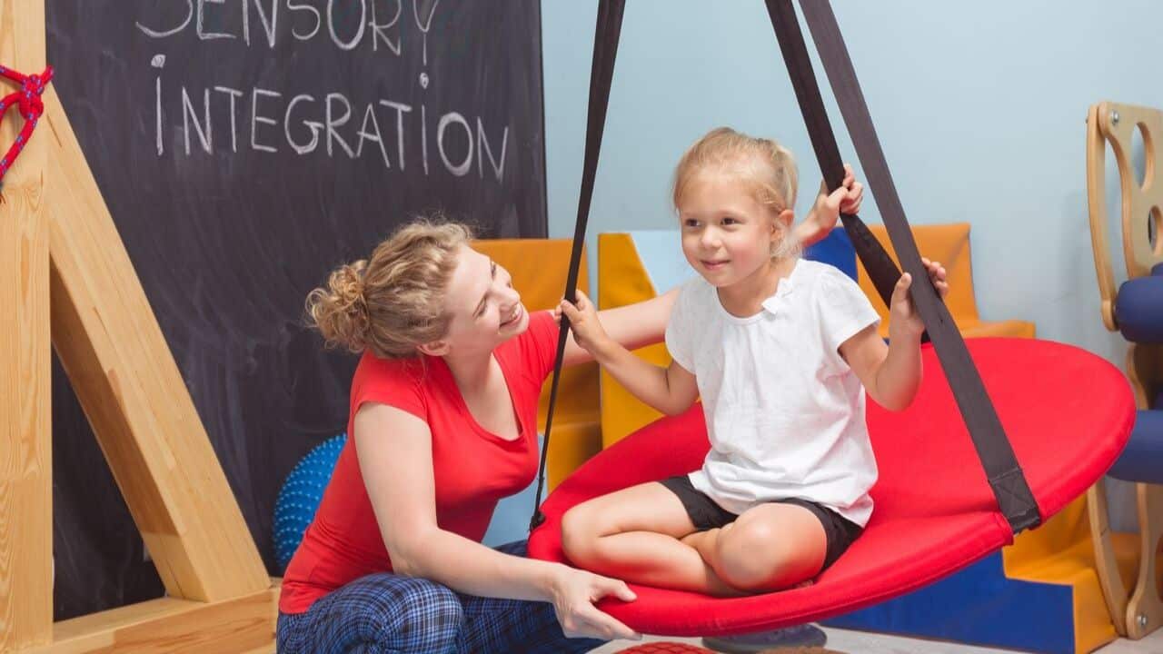 Child and therapist engaging in exercises in a sensory integration room