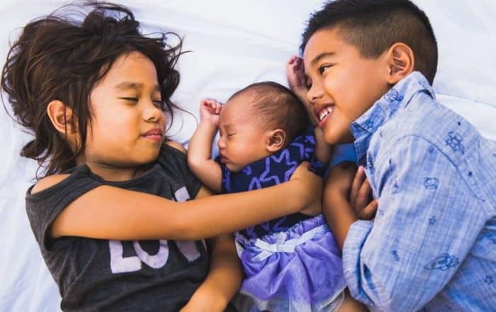 Three siblings hugging each other