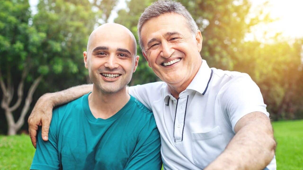 Two people sharing a hug and smiling