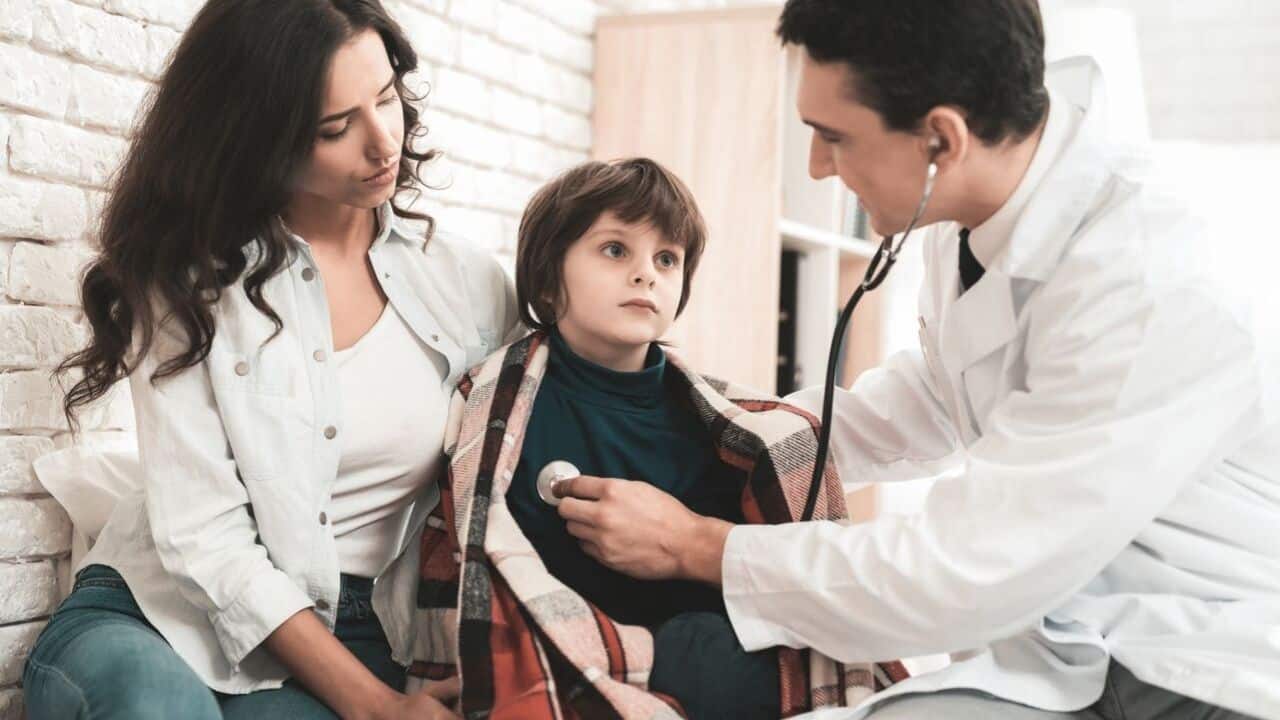 Healthcare professional assessing a young child