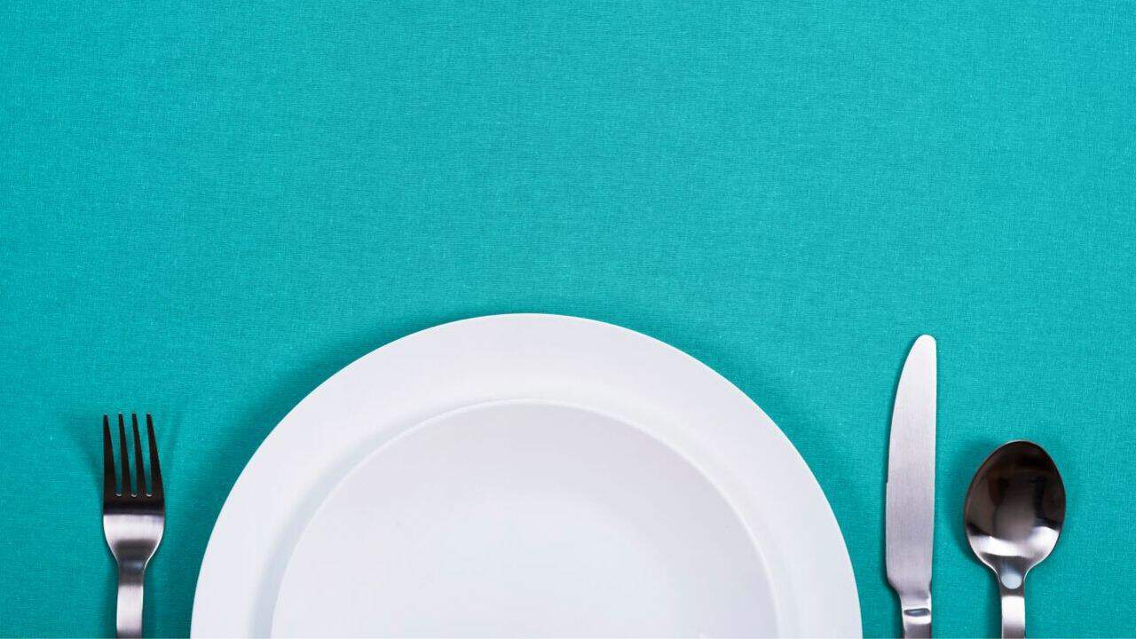 Plate and cutlery set on a blue background