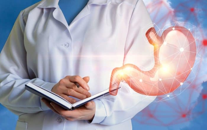 Medical professional holding a notebook while standing