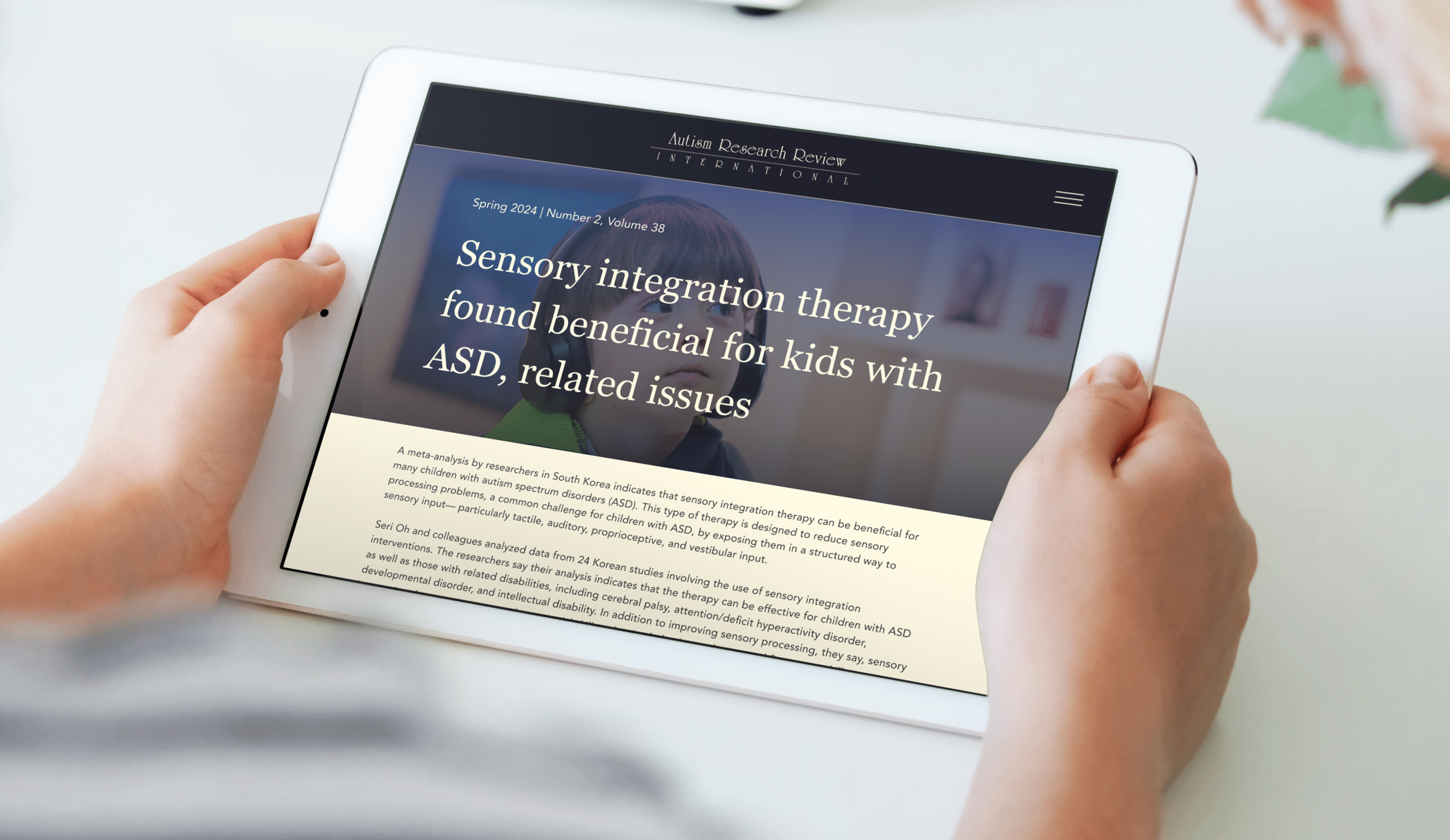 Person holding an iPad reading an article on the ARRI website